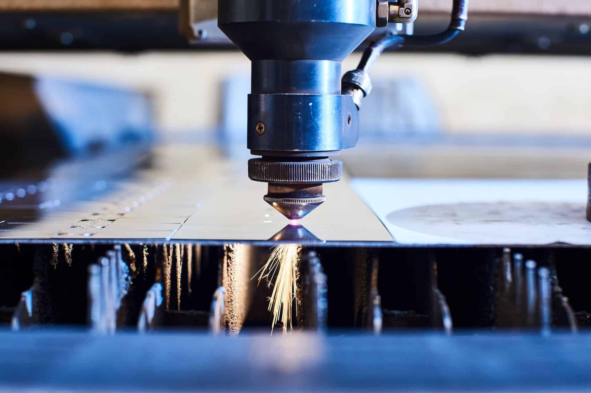 Laser Slag & Dross Removal for Stainless Steel Components CNC Laser cutting of metal close up, modern industrial technology. Small depth of field Laser Slag & Dross Removal for Stainless Steel Components